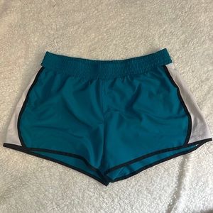 Large Tek Gear athletic shorts. Mostly blue, sides are white with black lining.